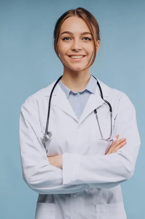 Dr. Emily Carter smiling with her arms crossed and a stethoscope round her neck