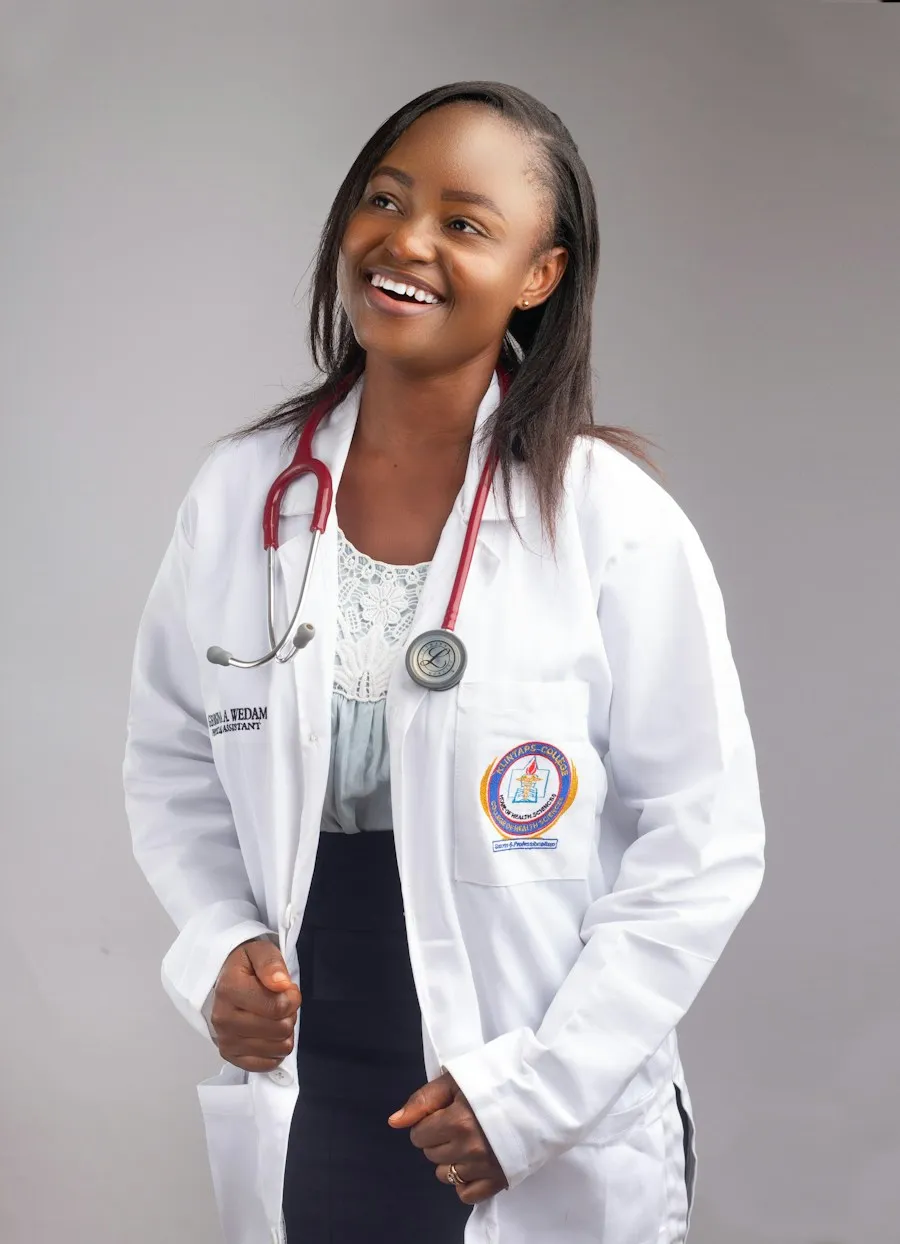 Dr. Grace Mensah smiling in a white coat with a stethoscope