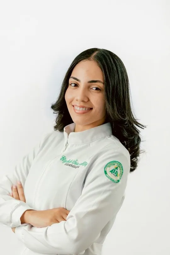 Dr. Isabella Cruz smiling with her arms crossed in a white coat
