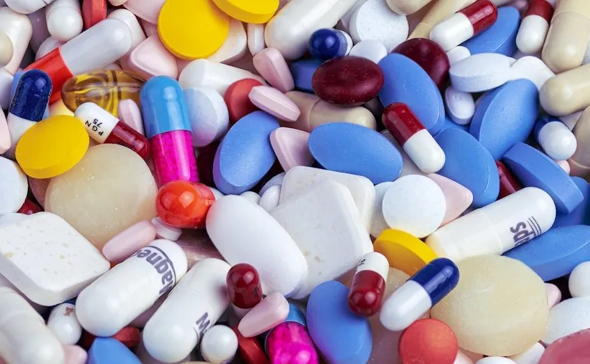 A pile of colourful tablets and capsules