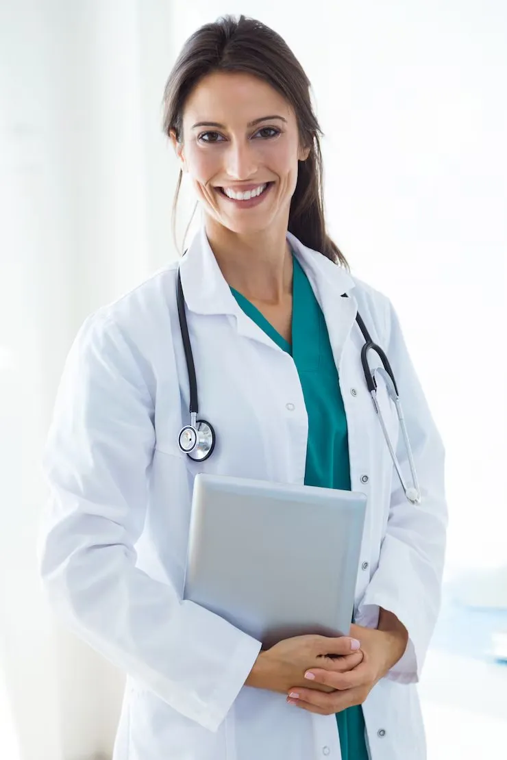 Dr. Sophia Reed smiling in a white coat, holding a tablet